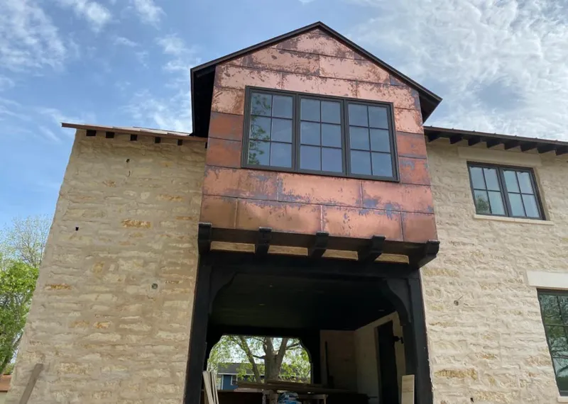 Copper metal panel facade on a stone building for Skylight Installation in Fredericksburg